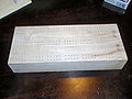 cribbage board in process, after burned peg holes with laser